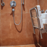 Accessible wet room shower with seat and grab rails