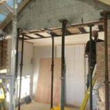 Temporary structural supports inside a Norfolk home during wall removal