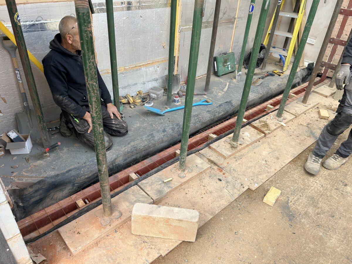Steel frame connection secured at floor level for the extension